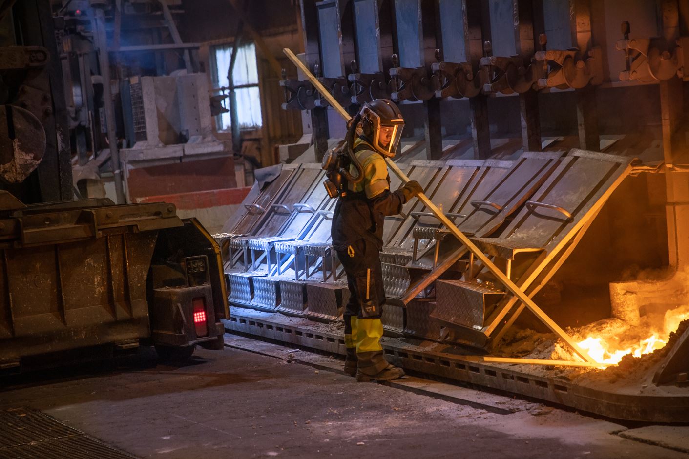 a firefighter standing next to a fire truck