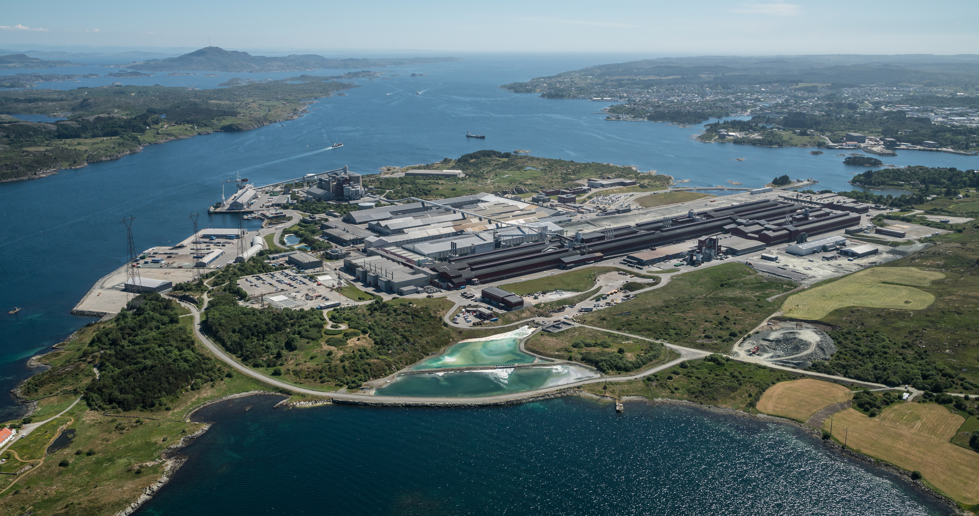 a large body of water with a city in the distance